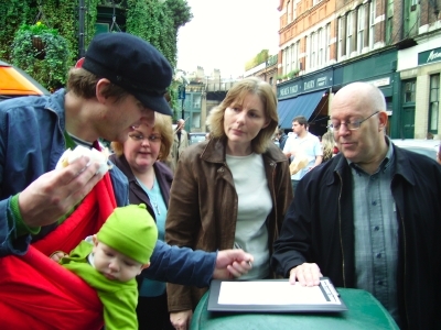 A local resident signs the petition watched by cou