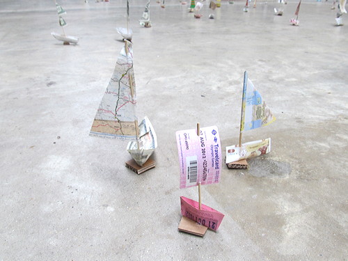 Tate Modern turbine hall filled with flotilla of paper boats