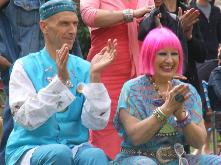 Andrew Logan and Zandra Rhodes perched on a hay ba