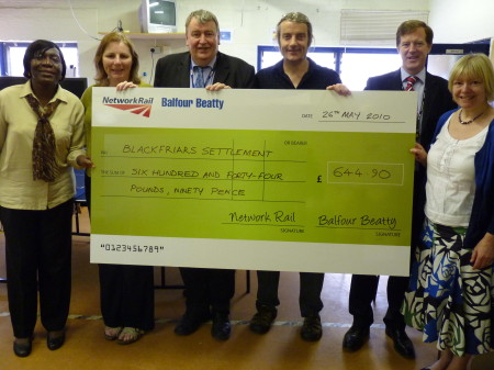 Blackfriars Station workers present cheque to local charity