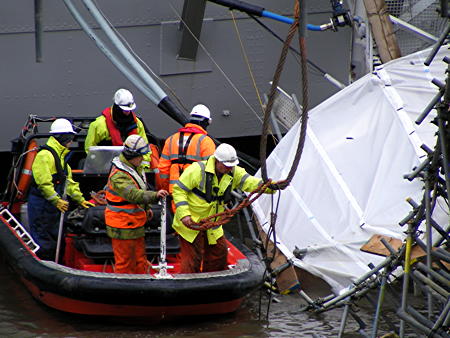 Giant crane lifts HMS Belfast’s collapsed gangway out of the river