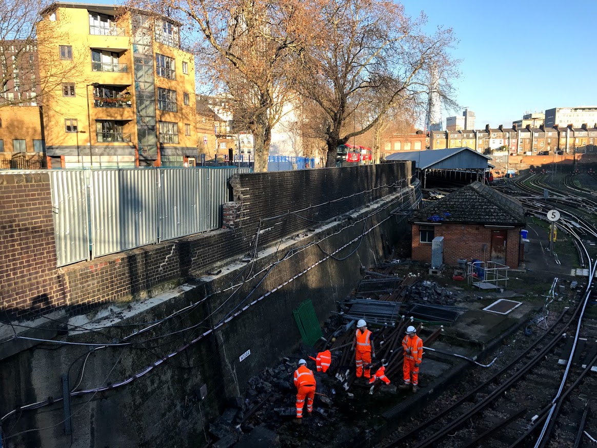 Car crashes into tube depot wall, scattering bricks on track