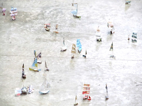 Tate Modern turbine hall filled with flotilla of paper boats