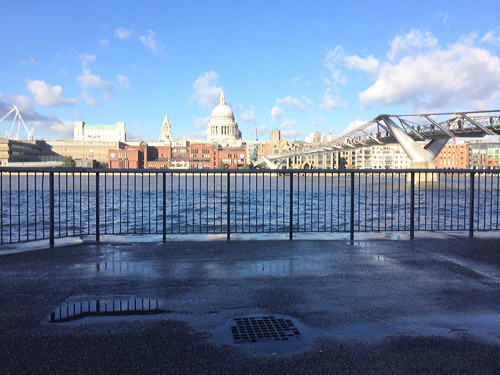 Waves break over Thames Path at Bankside after flood alert issued